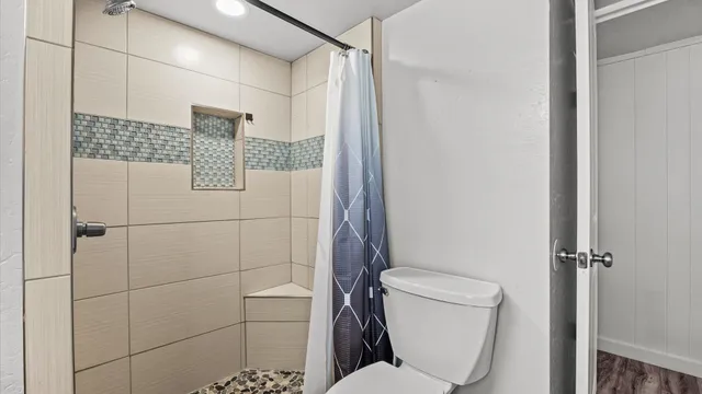 a bathroom with a toilet and shower