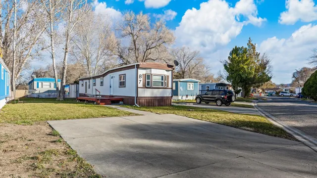 a view of swimming pool with outdoor seating and house in the background