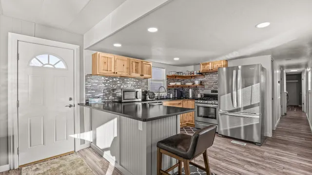a kitchen with kitchen island a counter top space cabinets and stainless steel appliances