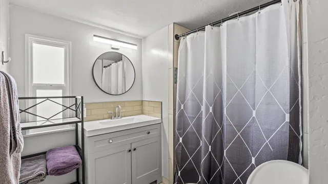 a bathroom with a sink mirror vanity and toilet