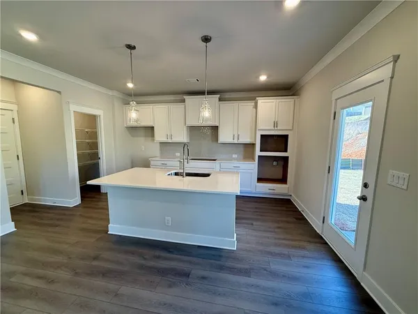 a view of kitchen with sink microwave and refrigerator