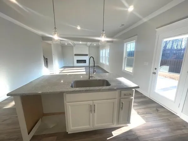 a kitchen with kitchen island a sink window and chairs