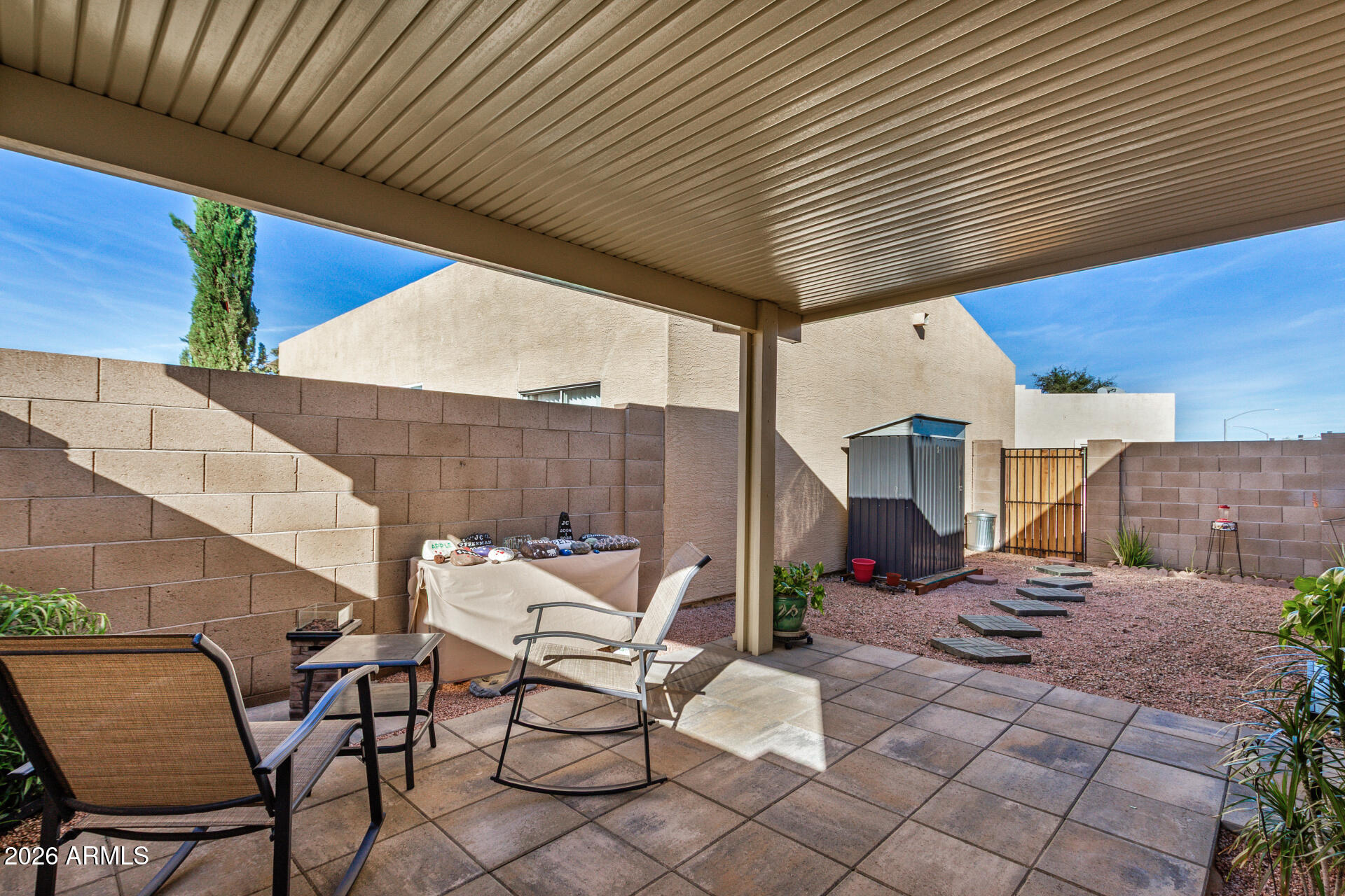 2300 East Magma Road, Unit 28 San Tan Valley, AZ 85143 - Photo 20 of 23 a patio with table and chairs and potted plants