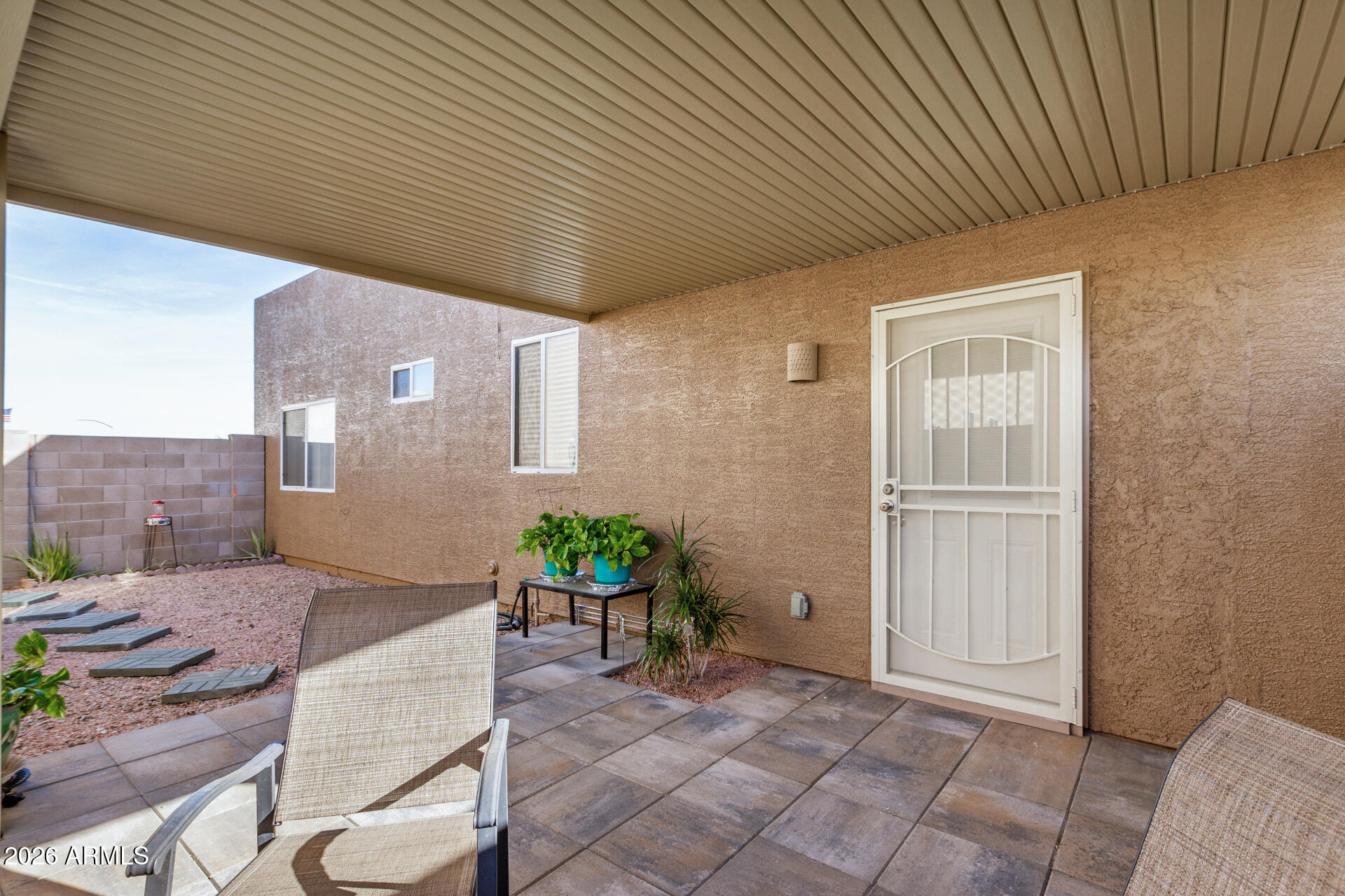 2300 East Magma Road, Unit 28 San Tan Valley, AZ 85143 - Photo 3 of 23 a backyard of a house with chairs