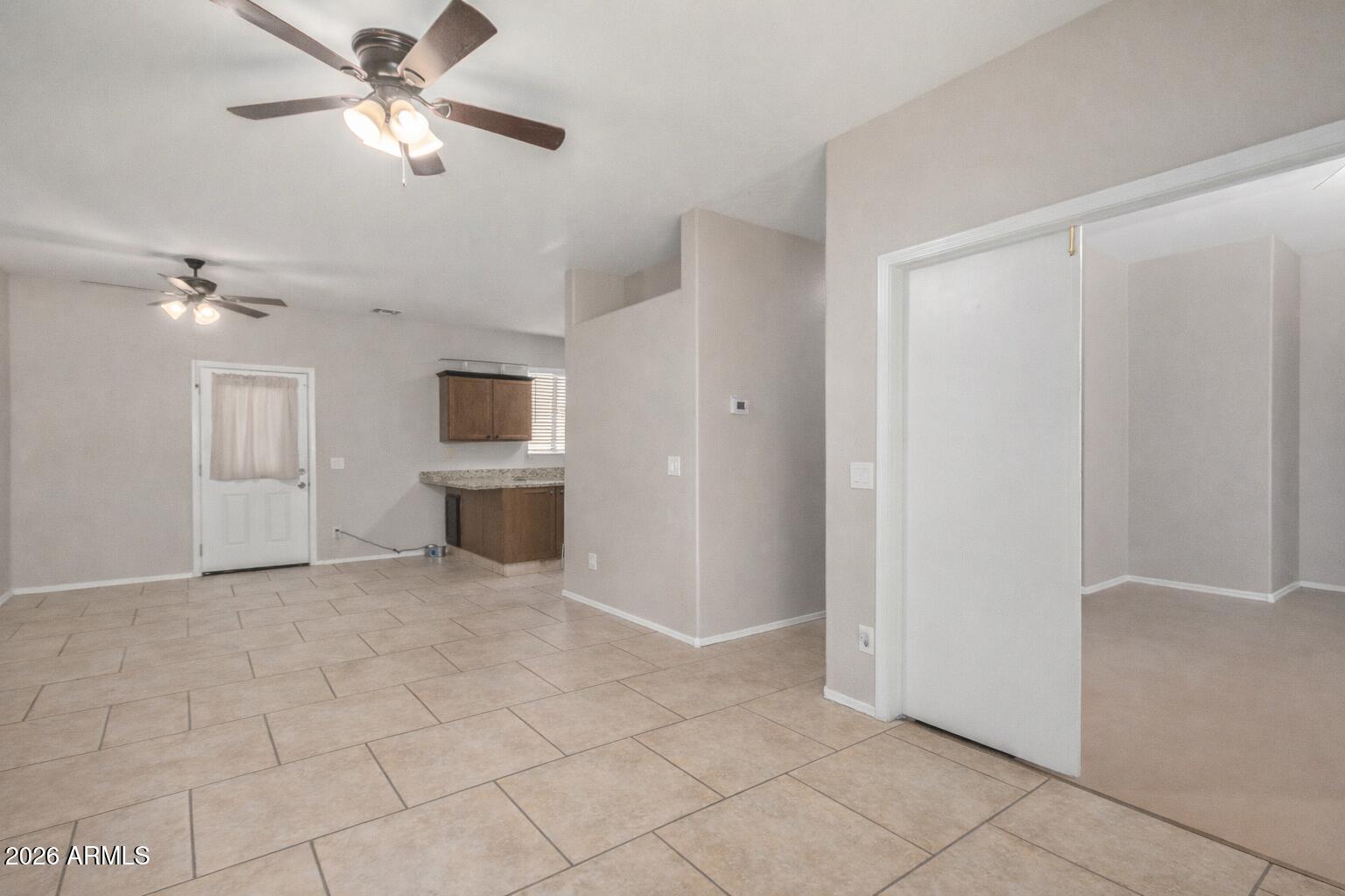 2300 East Magma Road, Unit 28 San Tan Valley, AZ 85143 - Photo 5 of 23 a view of a livingroom with an empty space and a ceiling fan