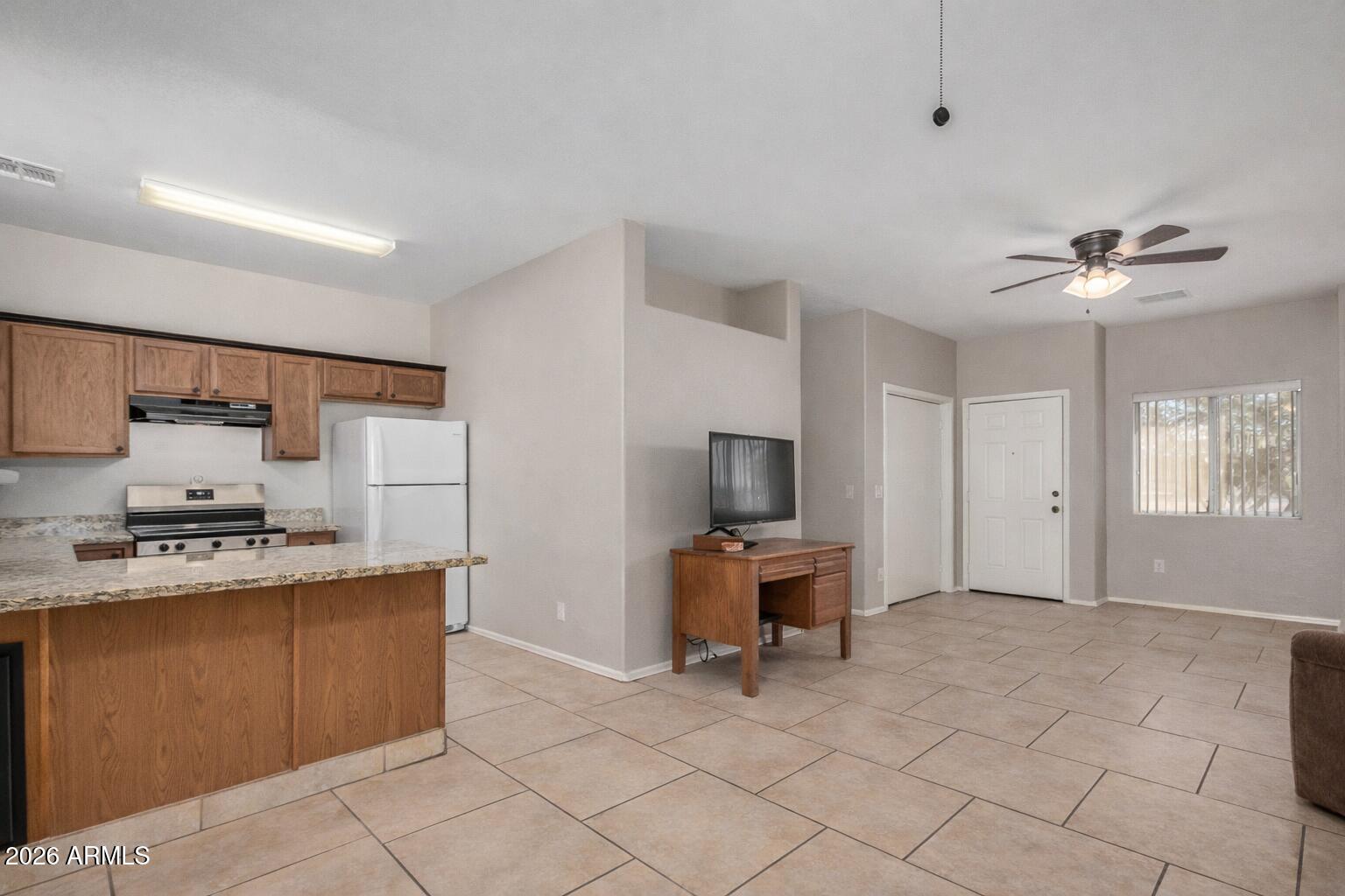 2300 East Magma Road, Unit 28 San Tan Valley, AZ 85143 - Photo 6 of 23 a living room with furniture and a flat screen tv