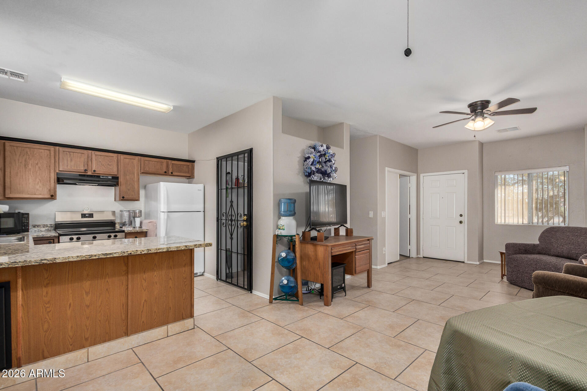 2300 East Magma Road, Unit 28 San Tan Valley, AZ 85143 - Photo 7 of 23 a living room with furniture a dining table and chairs