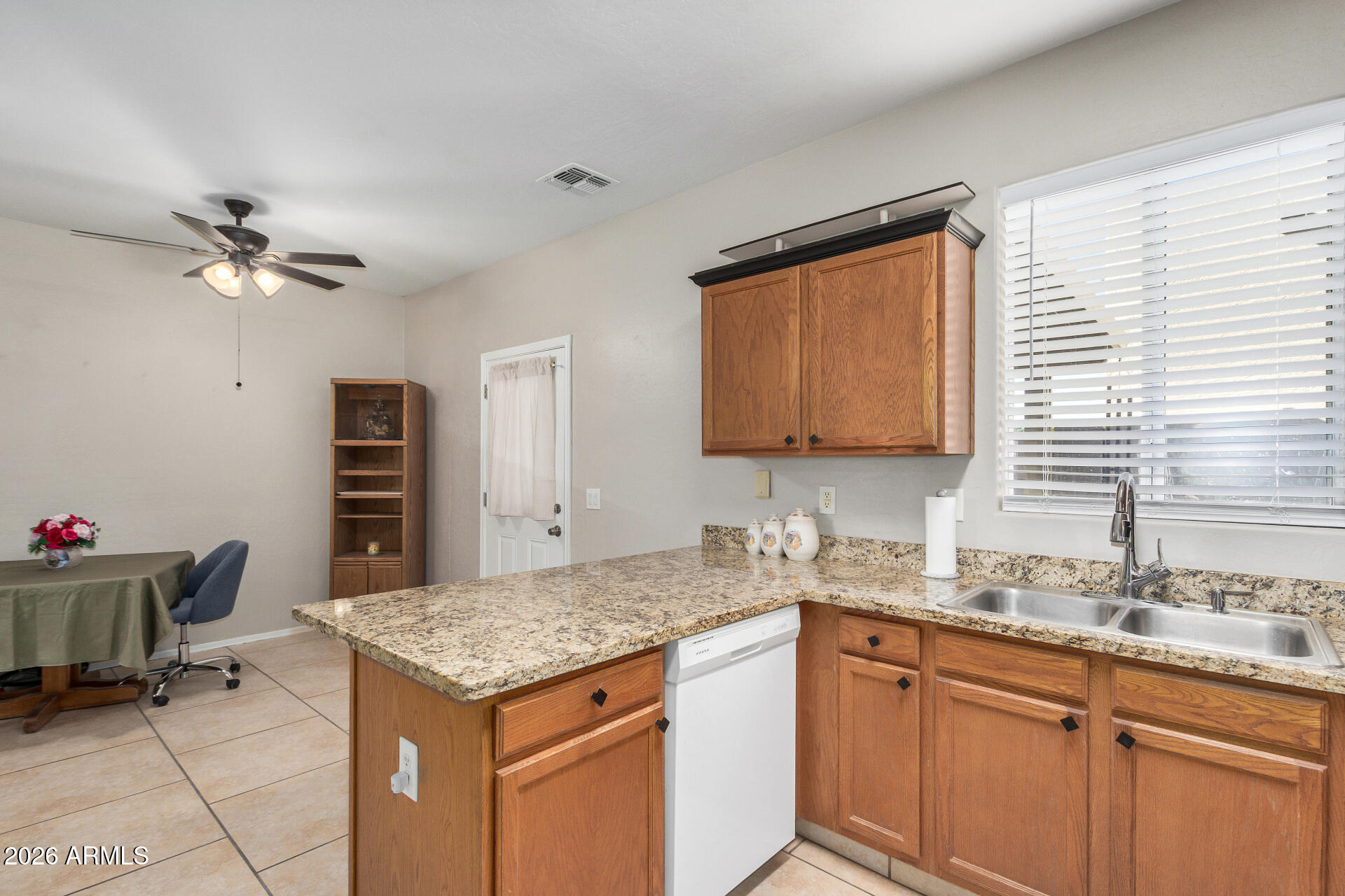 2300 East Magma Road, Unit 28 San Tan Valley, AZ 85143 - Photo 9 of 23 a kitchen with a stove a sink and a refrigerator