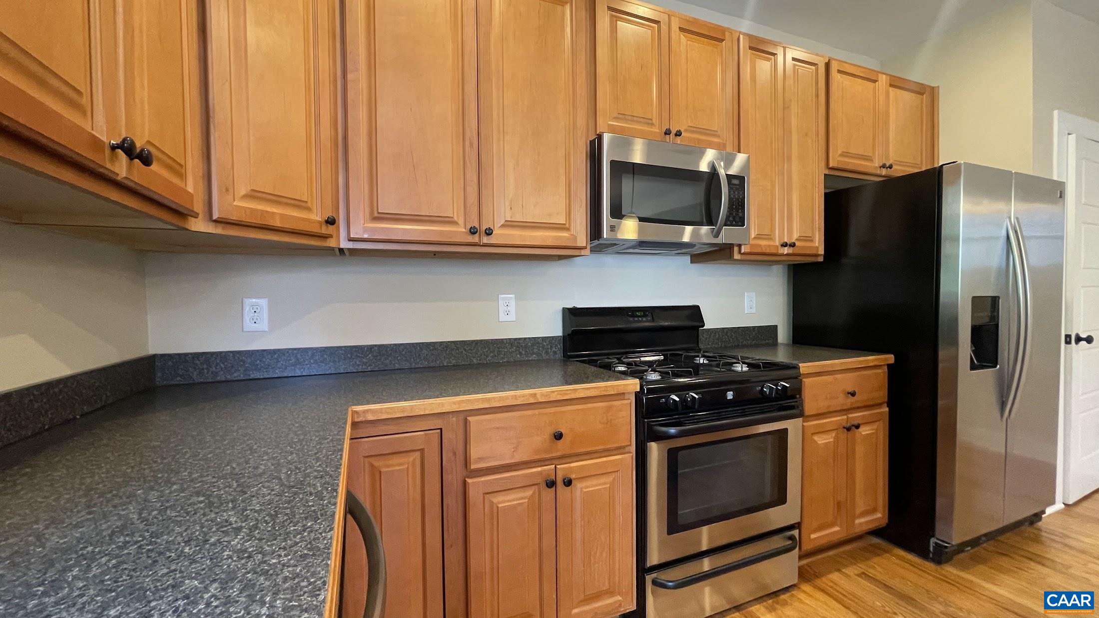 200 Harris Road Charlottesville, VA 22903 - Photo 12 of 28 a kitchen with stainless steel appliances granite countertop a stove a refrigerator and a microwave