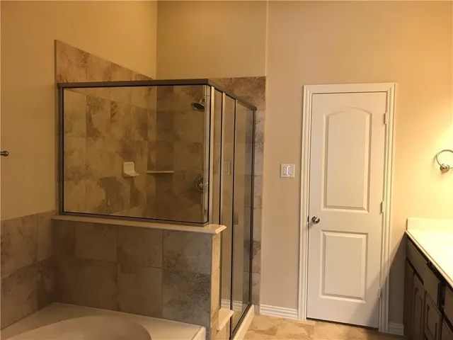 a bathroom with a glass door shower