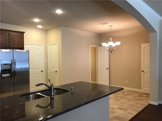 a bathroom with a granite countertop sink a mirror and shower