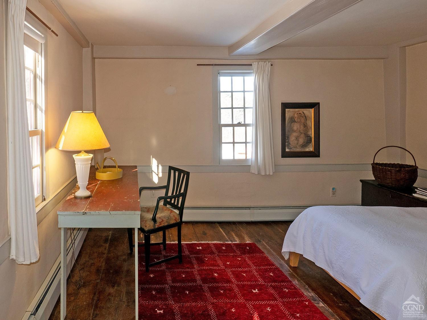 2216 County Rte 5 Canaan, NY 12029 - Photo 12 of 28 a bedroom with a bed and a lamp next to a window