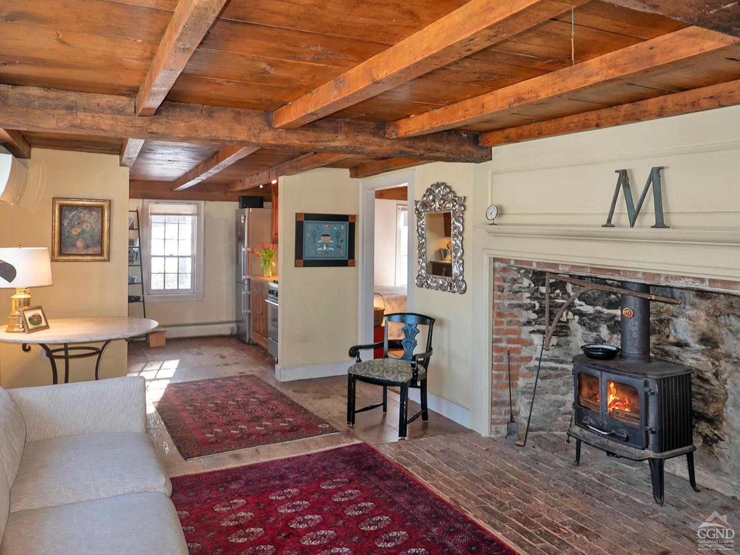 2216 County Rte 5 Canaan, NY 12029 - Photo 2 of 28 a living room with furniture a flat screen tv and a fireplace