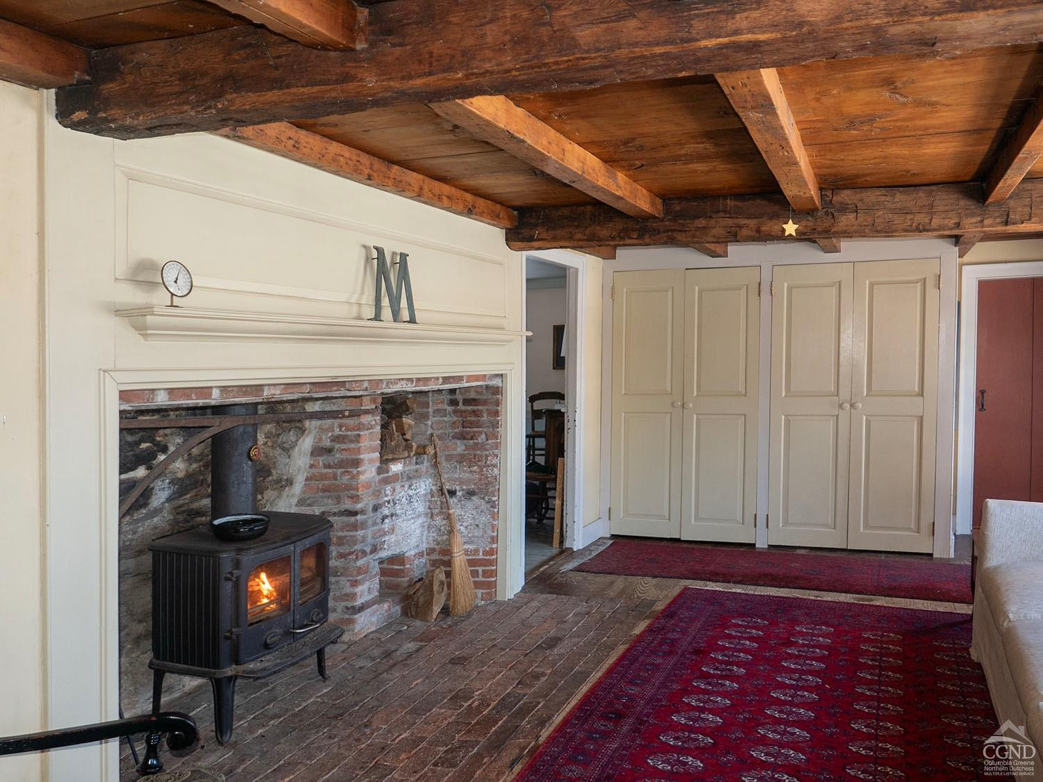2216 County Rte 5 Canaan, NY 12029 - Photo 3 of 28 a view of an empty room with wooden floor fireplace and a window