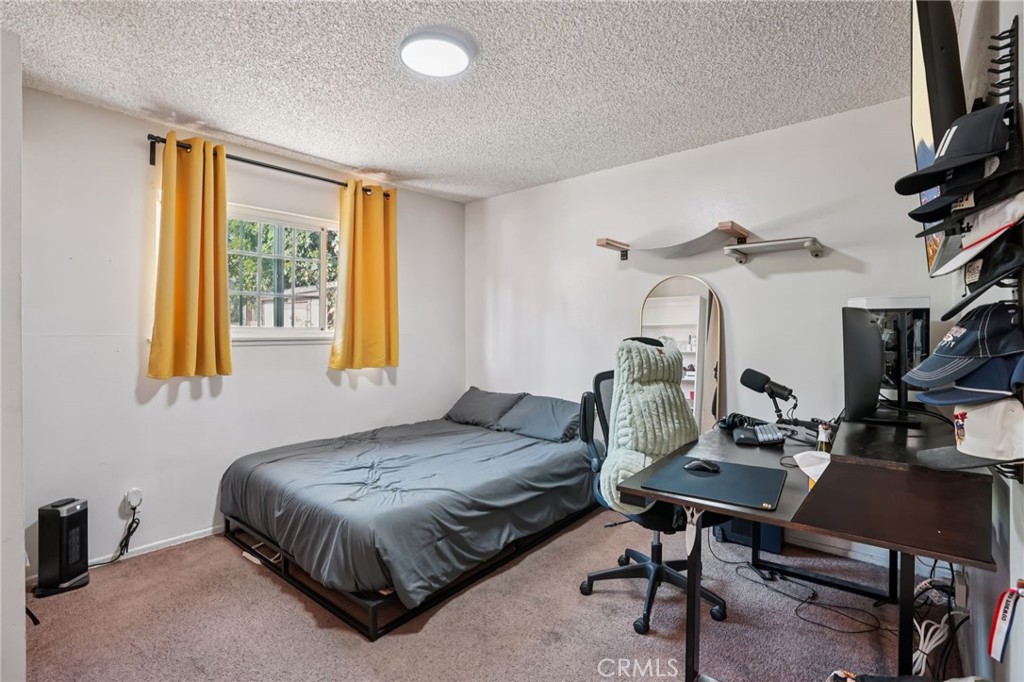 215 South Rock River Road Diamond Bar, CA 91765 - Photo 20 of 32 a bedroom with a bed and a desk