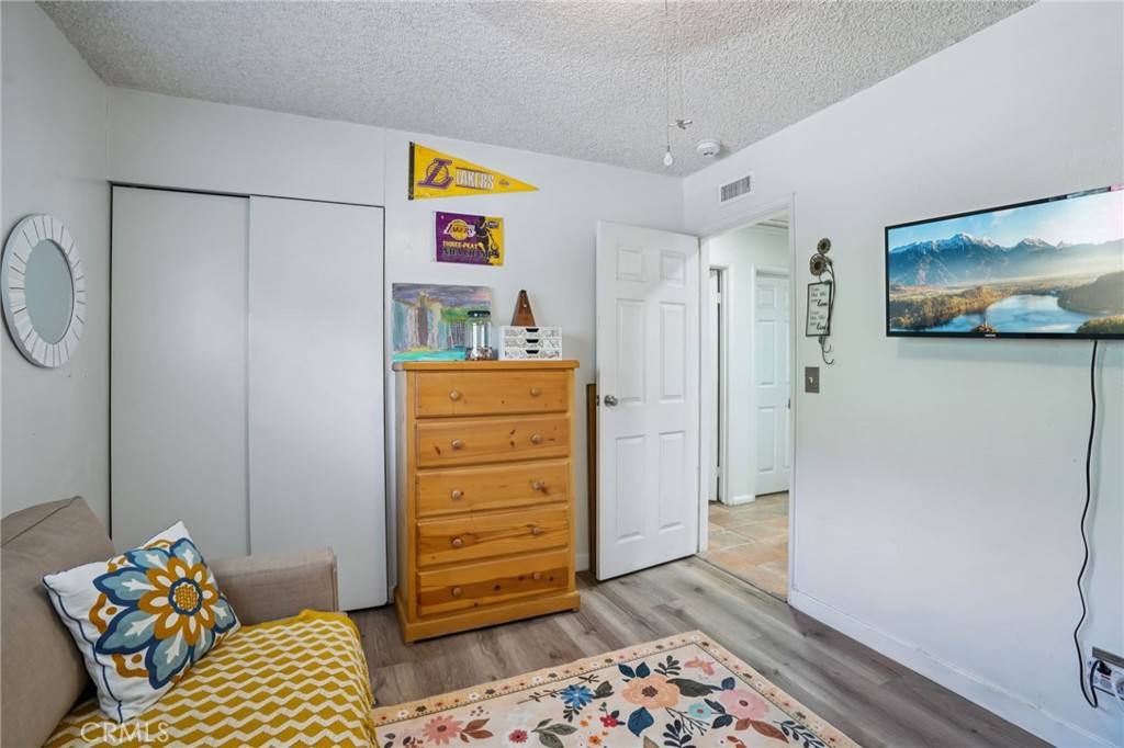 215 South Rock River Road Diamond Bar, CA 91765 - Photo 21 of 32 a bedroom with a bed and wooden floor