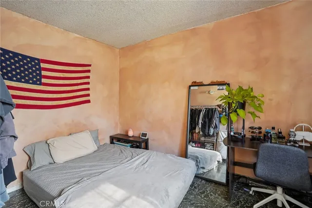 a bedroom with a bed and a couch