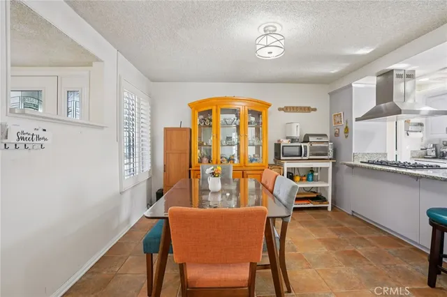 a dining room with furniture and a large window