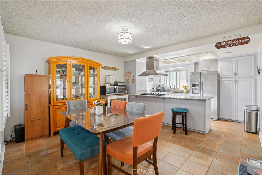215 South Rock River Road Diamond Bar, CA 91765 - Photo 5 of 32 a dining room with stainless steel appliances a table and chairs