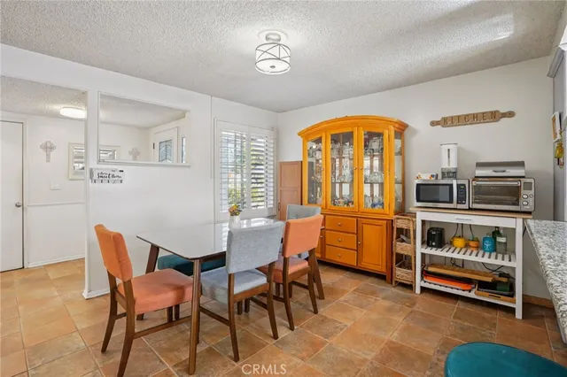 a view of a dining room with furniture and a window