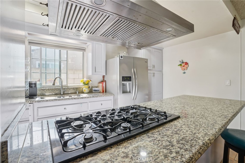 215 South Rock River Road Diamond Bar, CA 91765 - Photo 9 of 32 a kitchen with stainless steel appliances granite countertop a sink stove and refrigerator