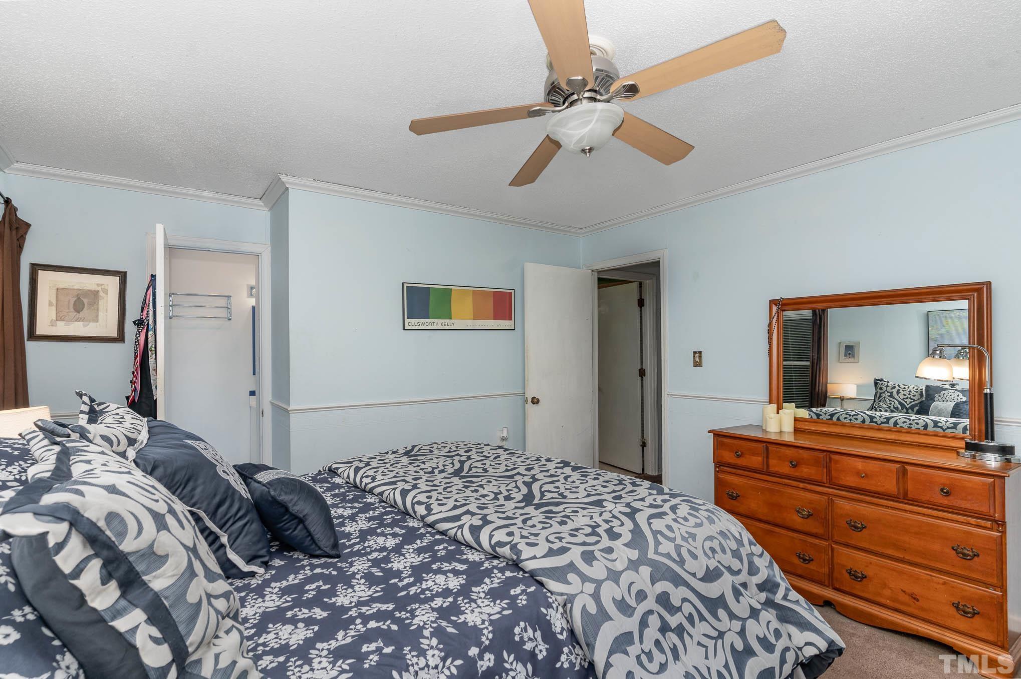3233 Banks Road Raleigh, NC 27603 - Photo 14 of 27 a bedroom with a bed and a dresser