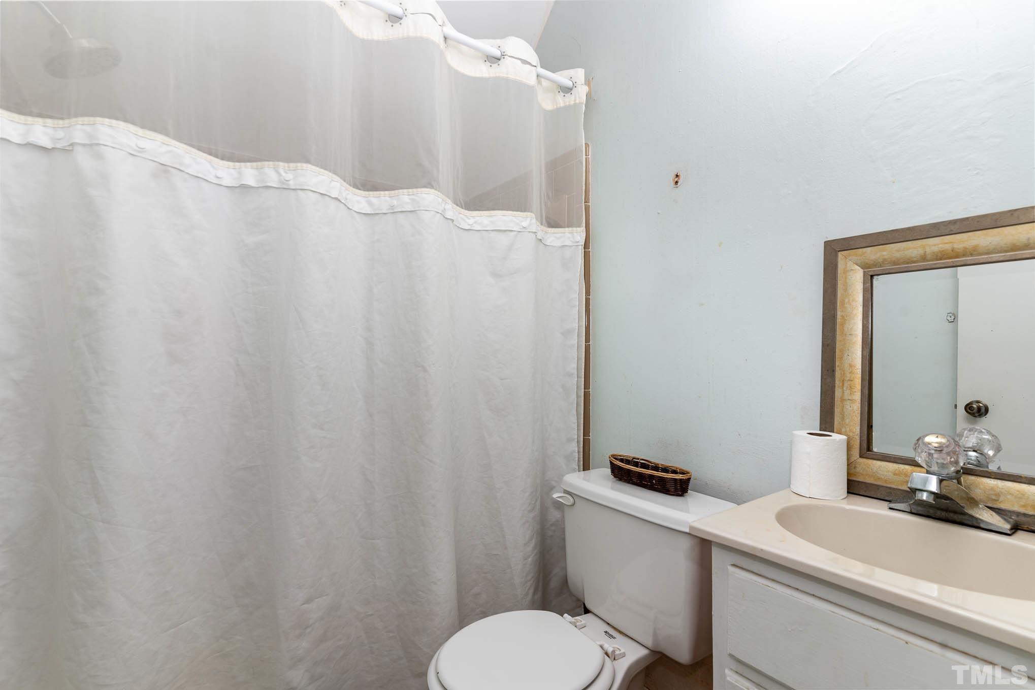 3233 Banks Road Raleigh, NC 27603 - Photo 19 of 27 a bathroom with a sink and toilet