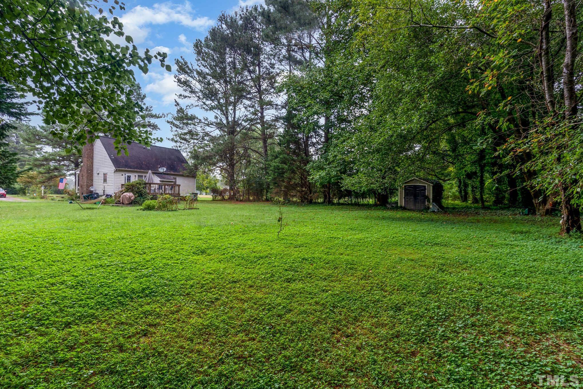 3233 Banks Road Raleigh, NC 27603 - Photo 25 of 27 a backyard of a house with lots of green space