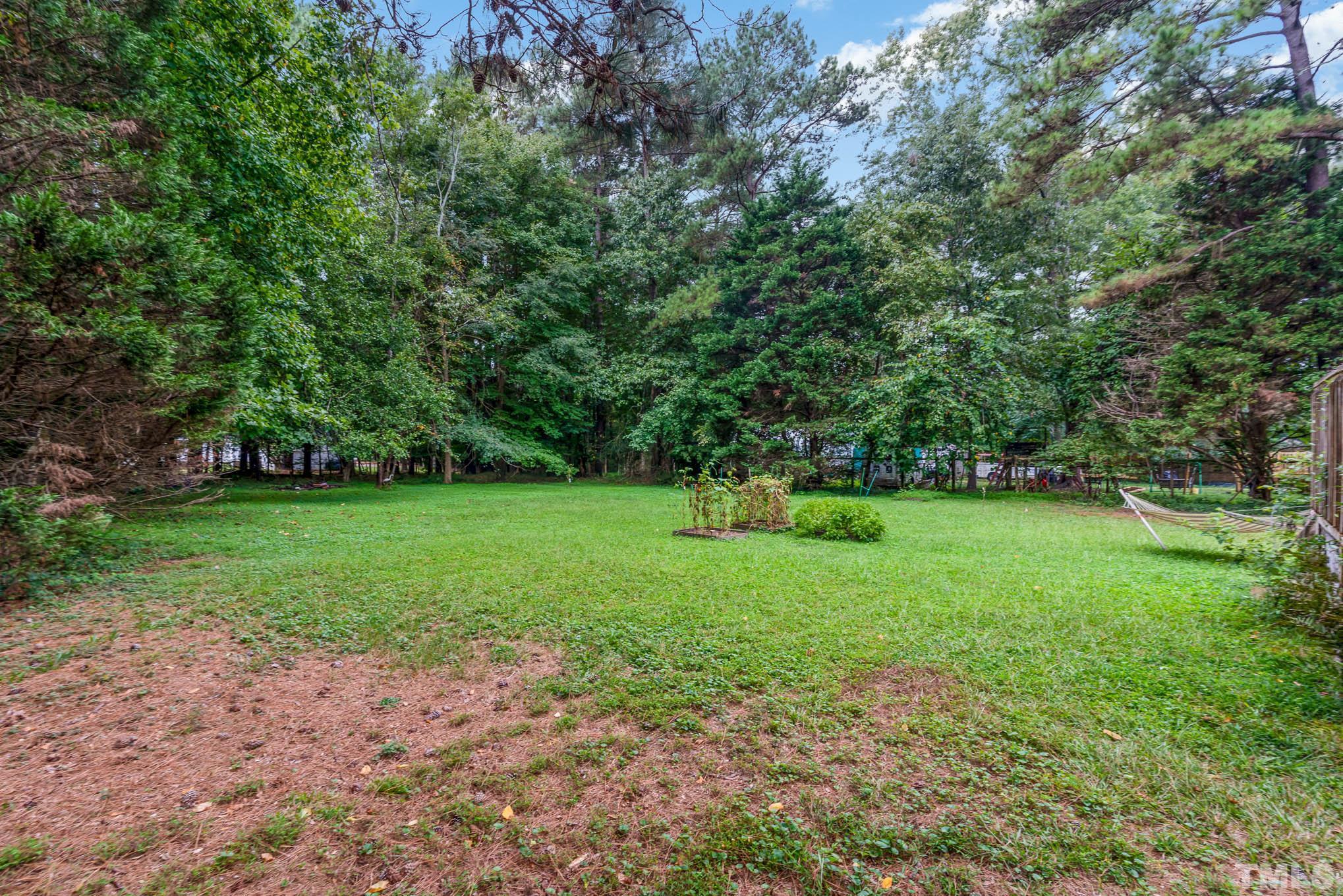 3233 Banks Road Raleigh, NC 27603 - Photo 27 of 27 a view of green field with trees in the background