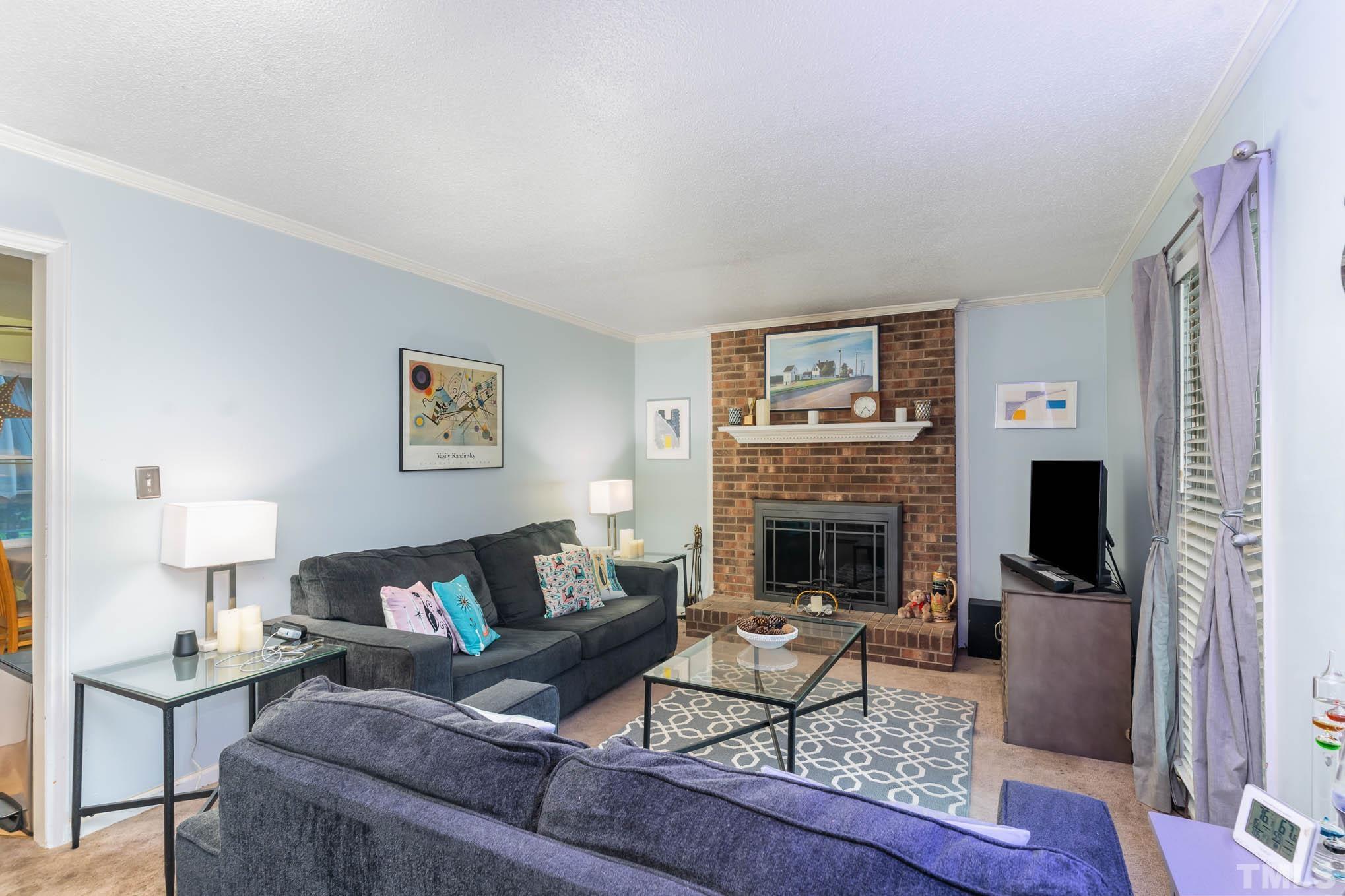 3233 Banks Road Raleigh, NC 27603 - Photo 5 of 27 a living room with furniture and a fireplace