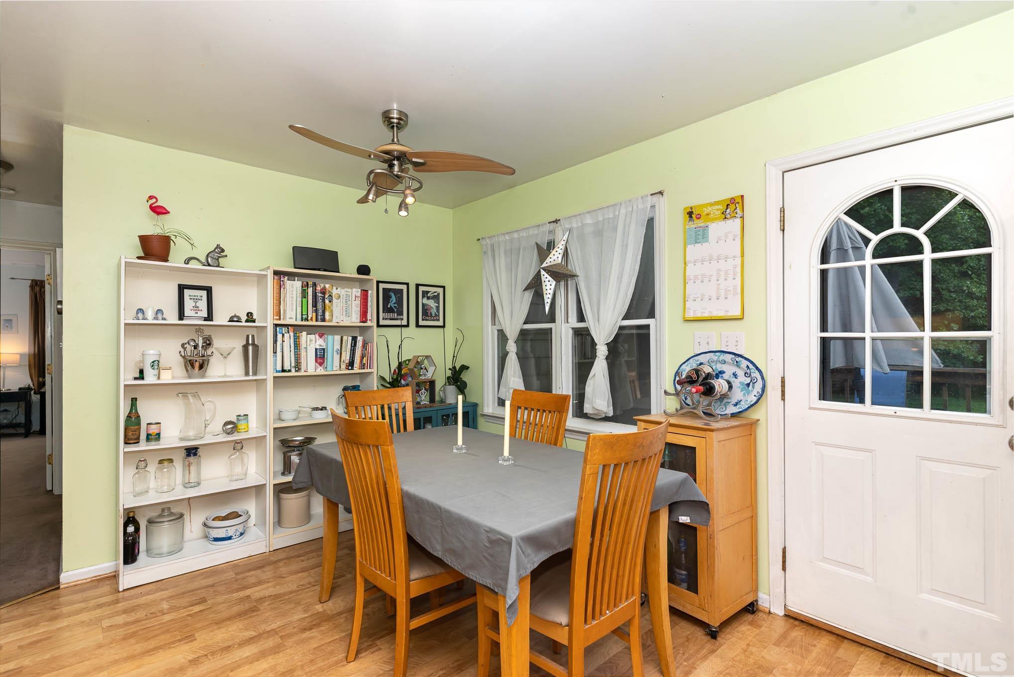 3233 Banks Road Raleigh, NC 27603 - Photo 10 of 27 a view of a dining room with furniture and a book shelf