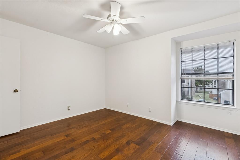4748 Old Bent Tree Lane, Unit 1808 Dallas, TX 75287 - Photo 13 of 28 wooden floor in an empty room with a window