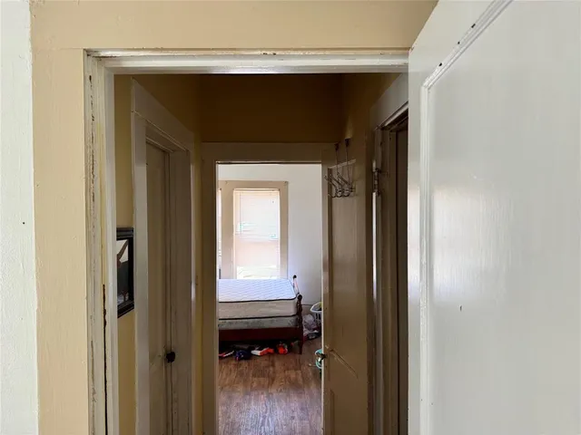 a kitchen with a sink cabinets and wooden floor