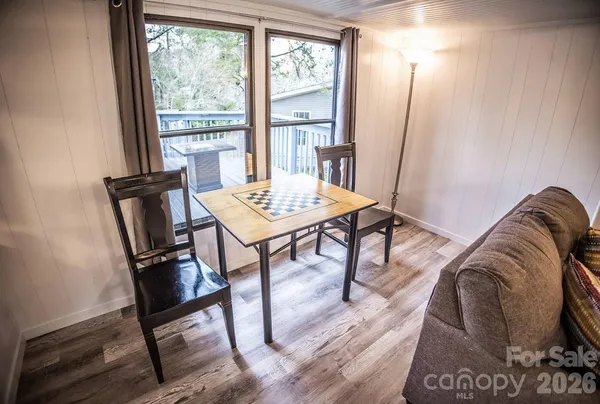 a view of a livingroom with furniture window and wooden floor