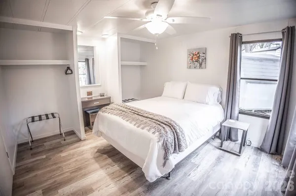 a bedroom with a bed and a mirror