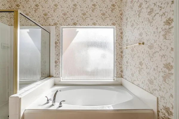 a bathroom with bathtub and a shower