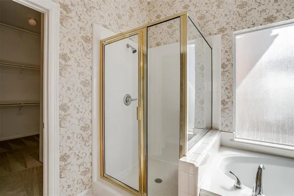a bathroom with a shower and a tub