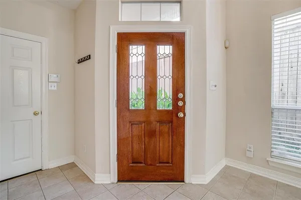 an entrance view of an entryway with wooden floor