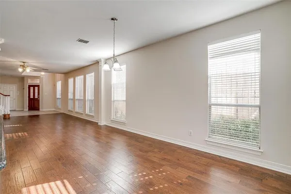 a view of a room with wooden floor and windows