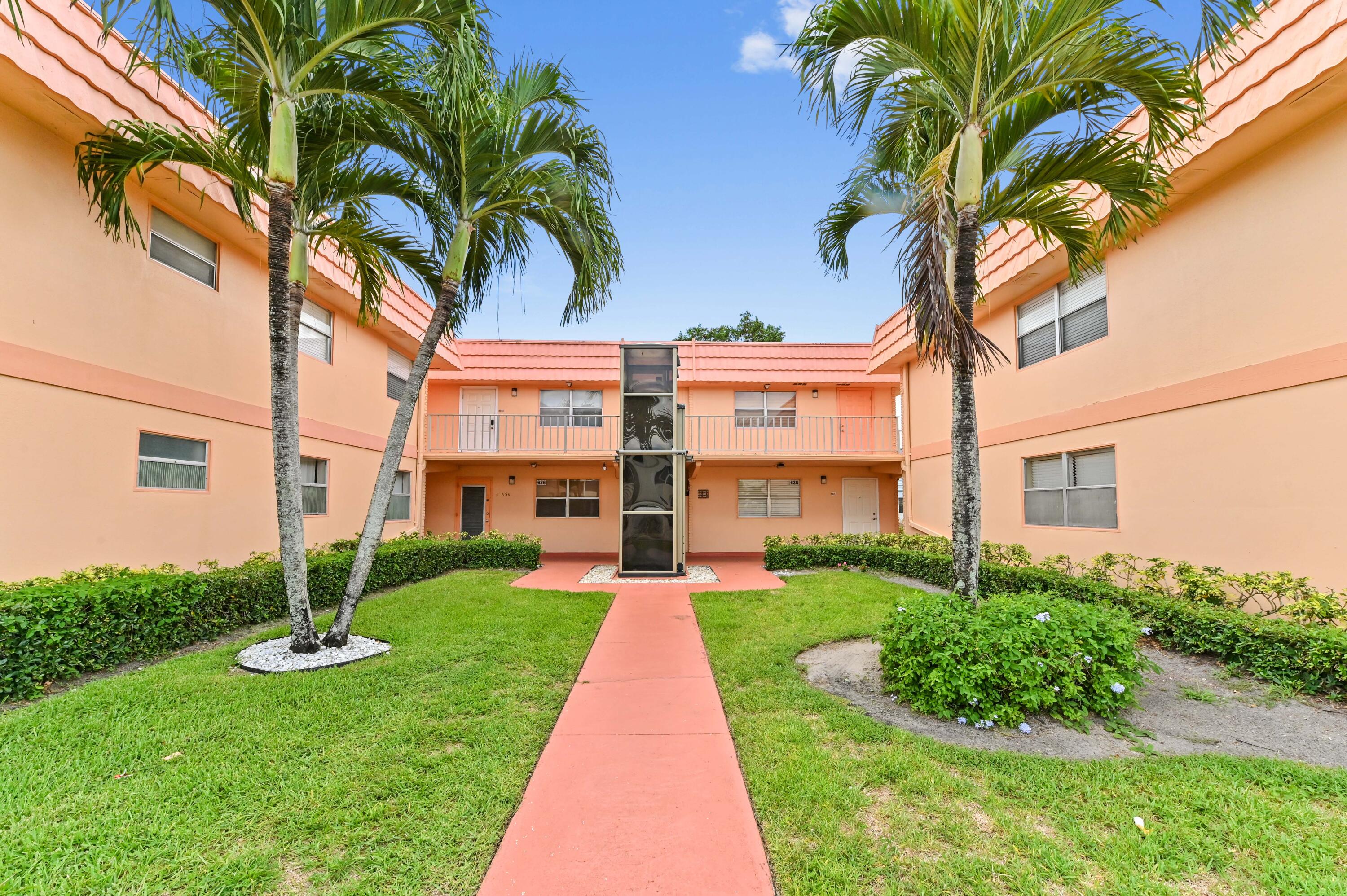 669 Saxony Place Delray Beach, FL 33446 - Photo 1 of 20 a front view of a house with garden