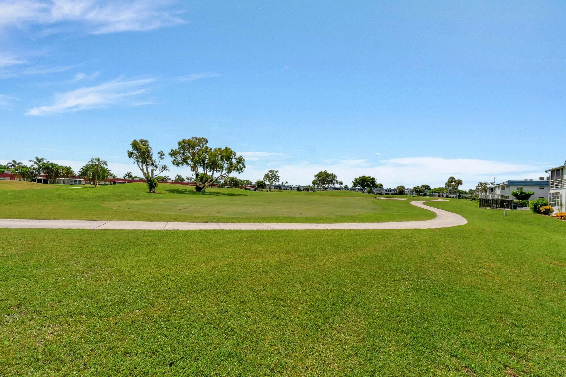 669 Saxony Place Delray Beach, FL 33446 - Photo 20 of 20 a view of a golf course with a lake