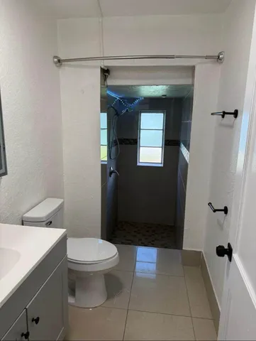 a bathroom with a toilet and a shower