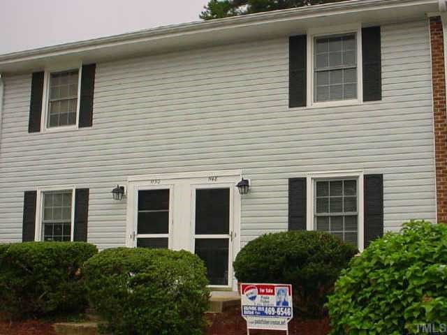 a view of a house with a yard and plants