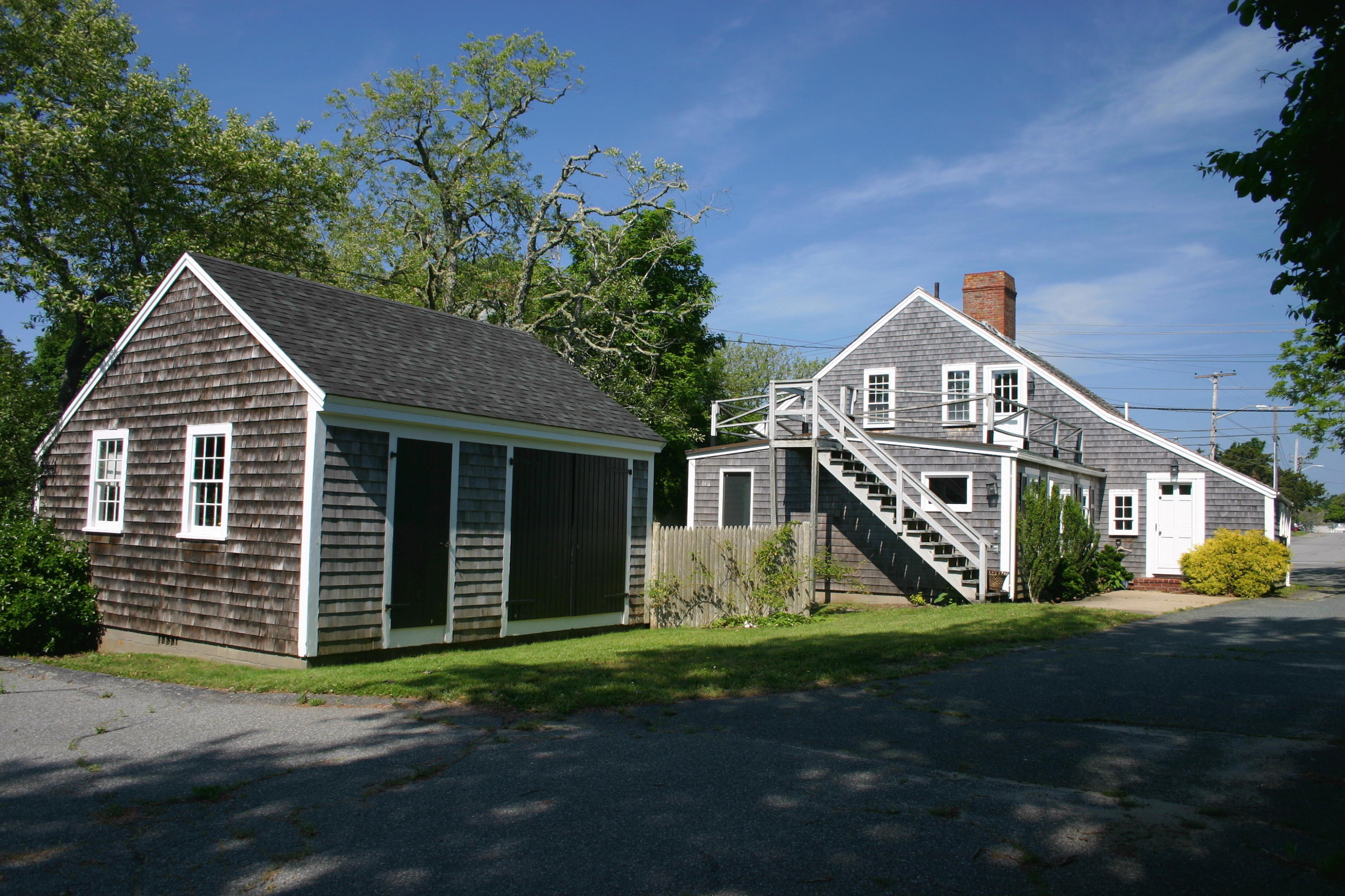 90 Old Harbor Road Chatham, MA 02633 - Photo 3 of 9 a front view of a house with a yard and garage