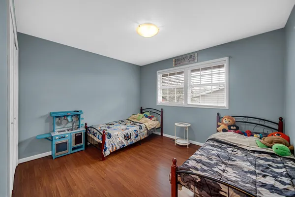 a bedroom with two beds and a window