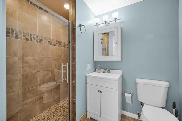 a bathroom with a toilet a sink and shower