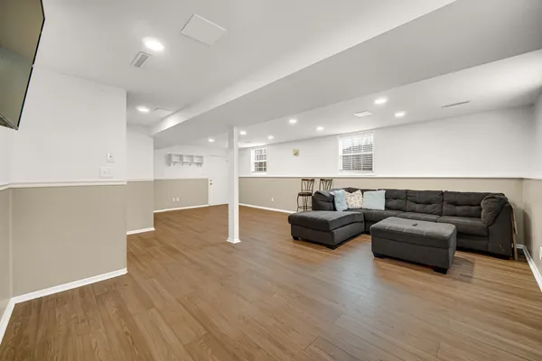 a living room with furniture and a wooden floor