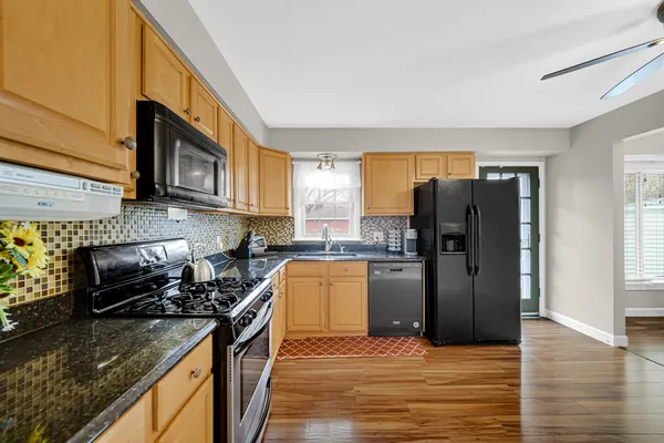 a kitchen with a refrigerator stove and microwave