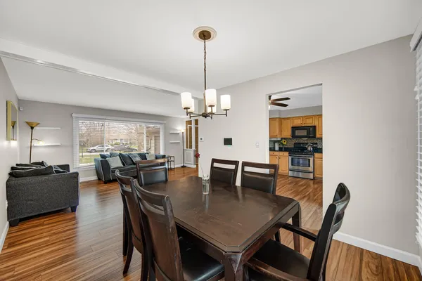 a view of a dining room with furniture window and wooden floor