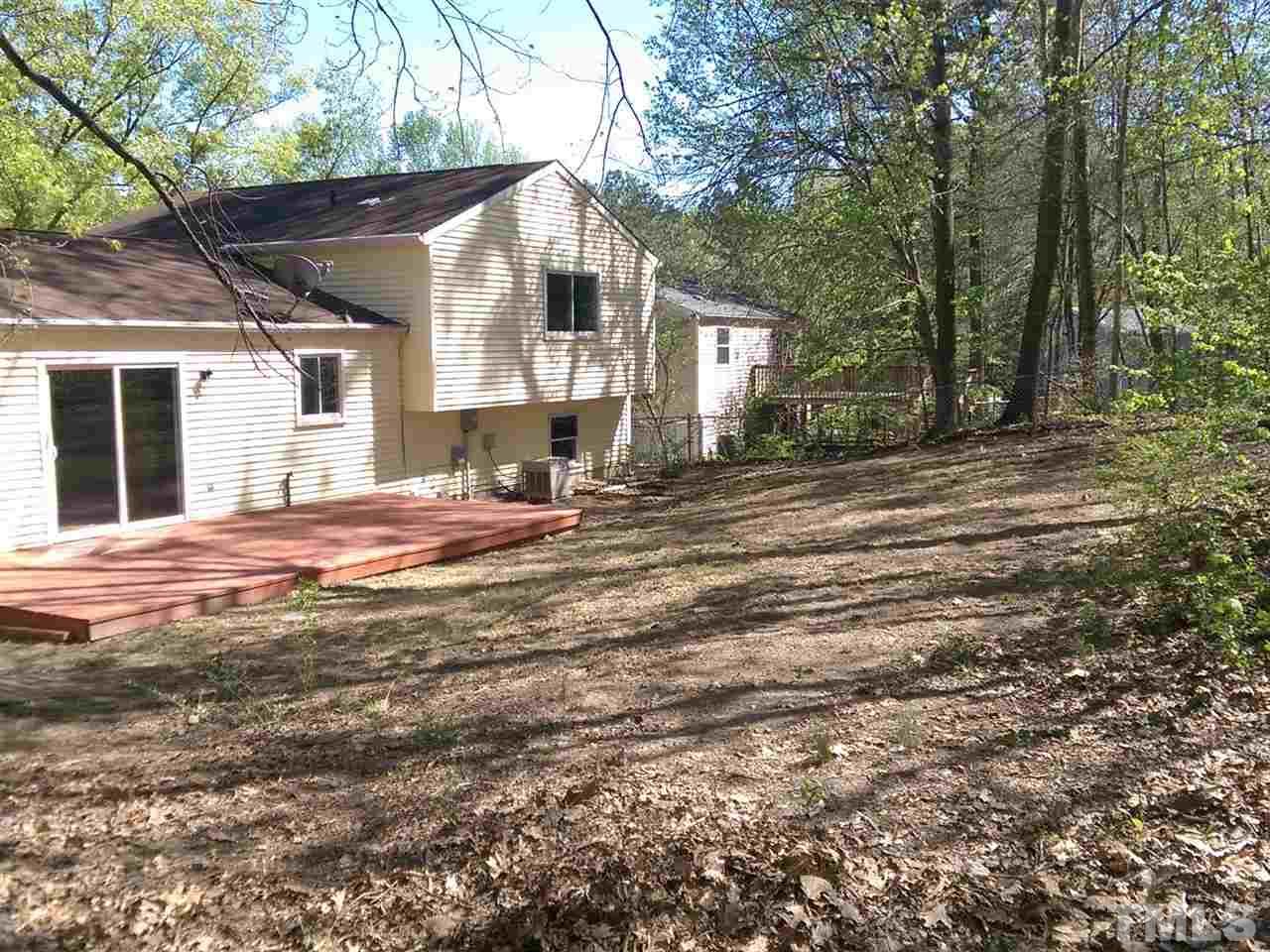 7909 Janet Court Raleigh, NC 27615 - Photo 22 of 25 a view of a house with backyard and trees